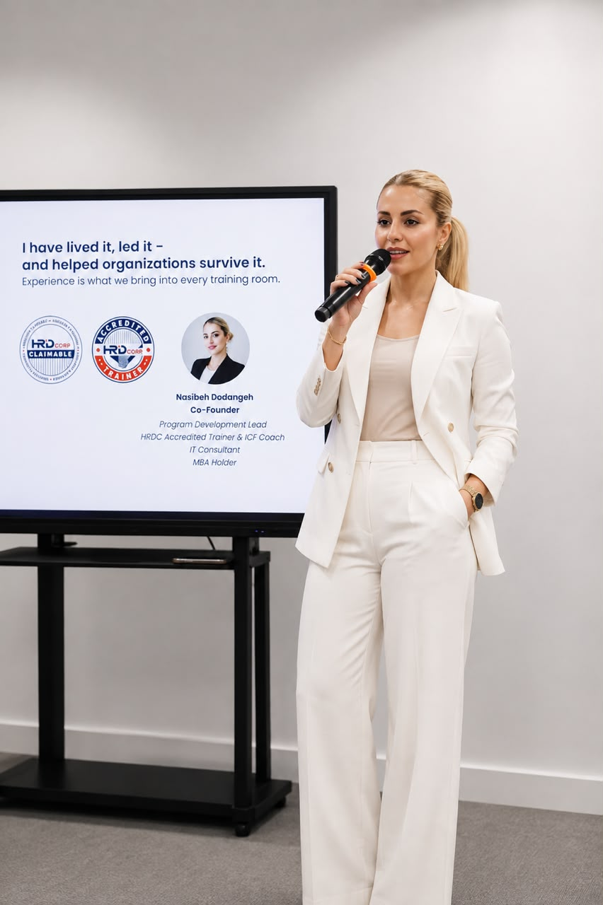Nasibeh Dodangeh, Founder and Executive Director of Kairos Arete, presenting in a white outfit