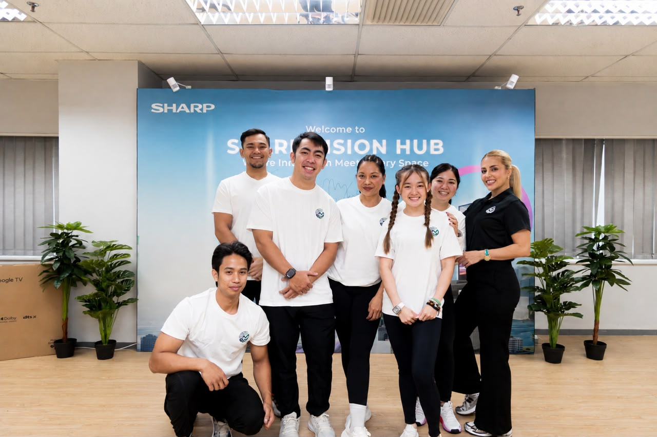 A group of participants posing together at a Sharp Vision Hub event