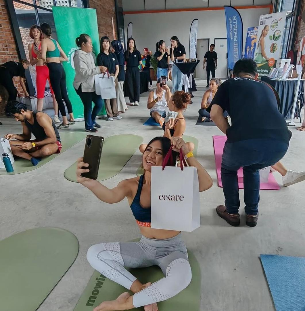 Participants seated on yoga mats during an indoor wellness event