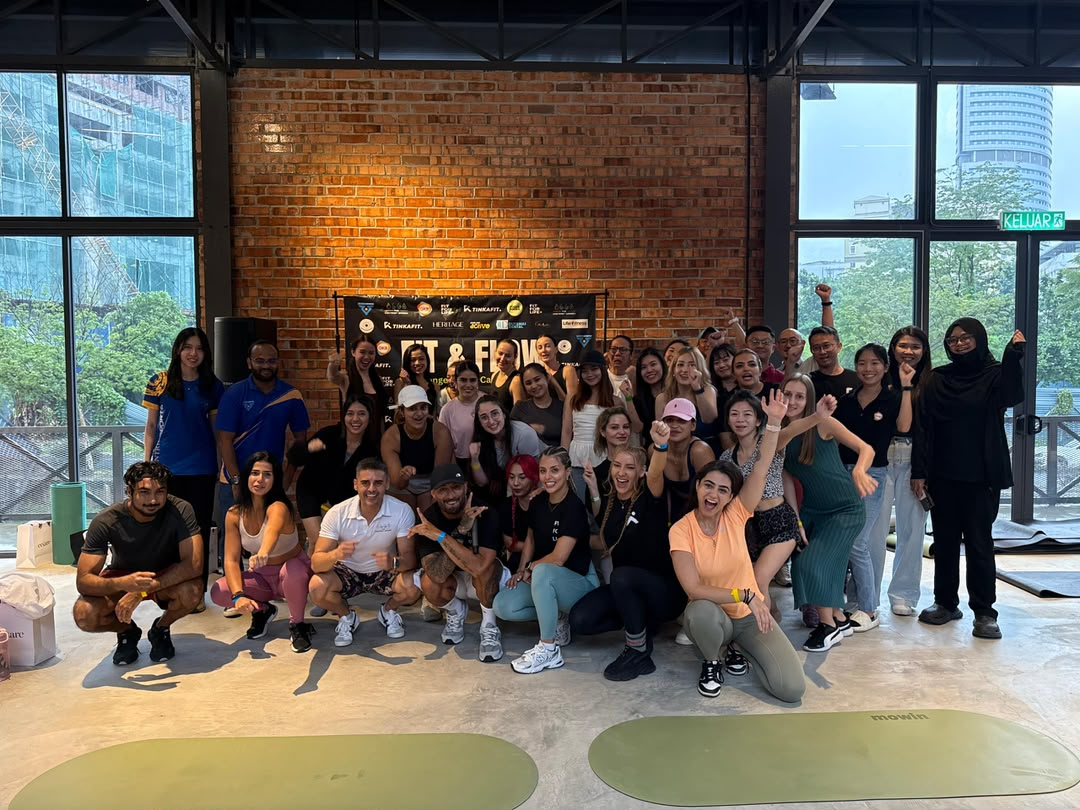 A large group posing together at a wellness event venue